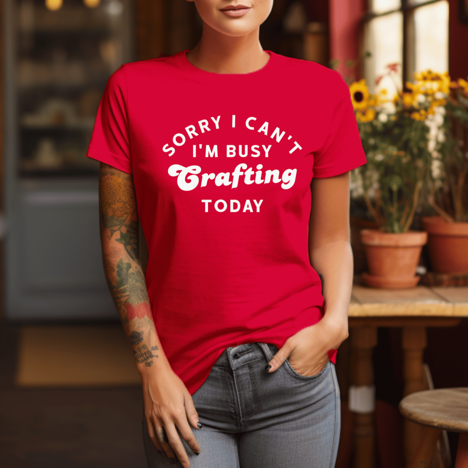 Woman wearing a red t-shirt with text in a cozy indoor setting
