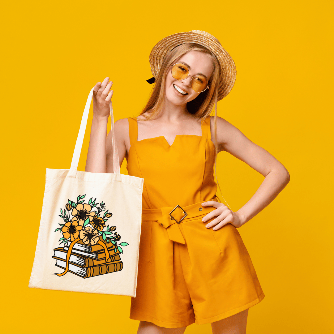 Woman in yellow outfit holding a tote bag with a floral and book design on a yellow background
