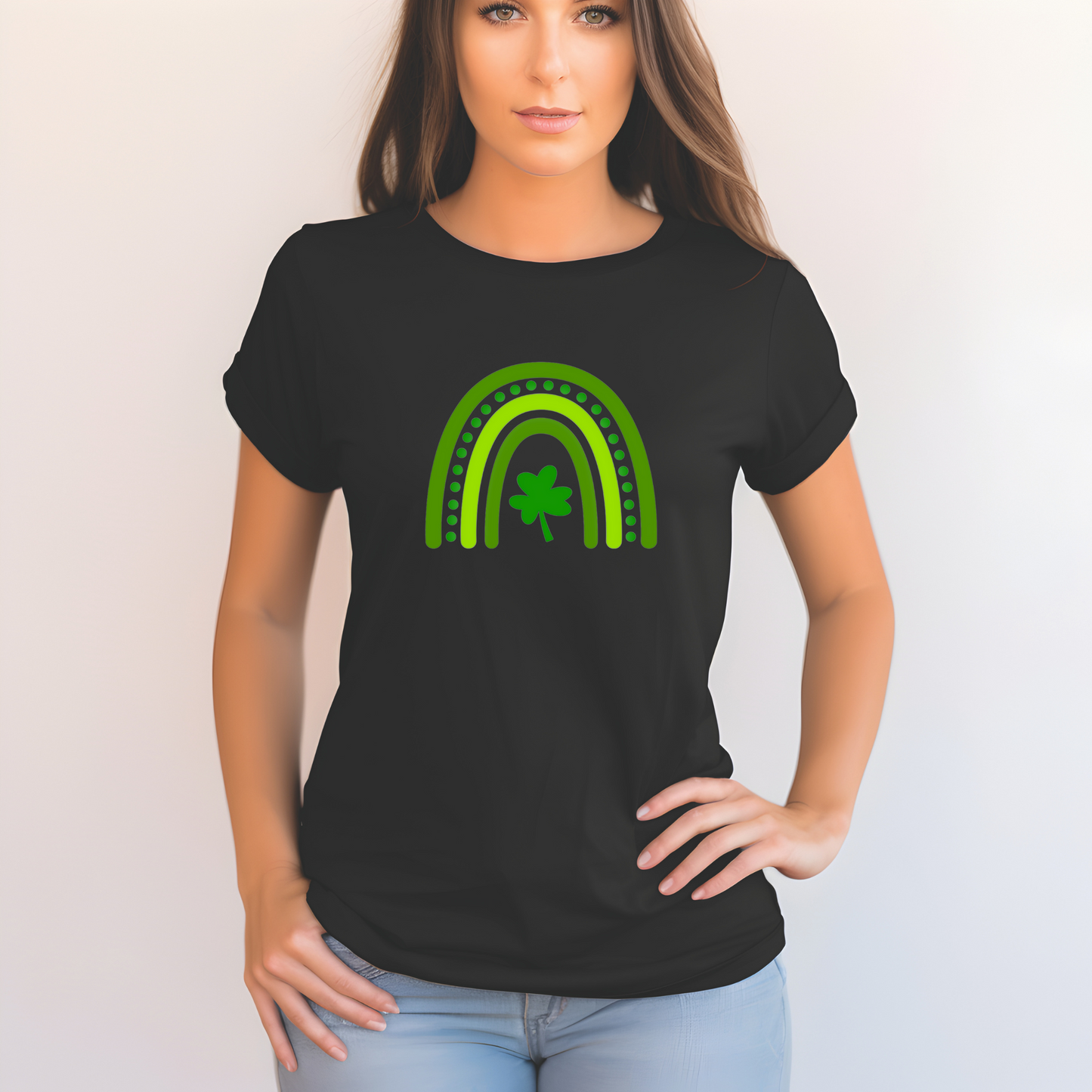 A stylized rainbow design with curved green stripes in varying shades, featuring a shamrock or clover at the center. The rainbow has dotted details between the arches, creating a festive St. Patrick's Day themed graphic.