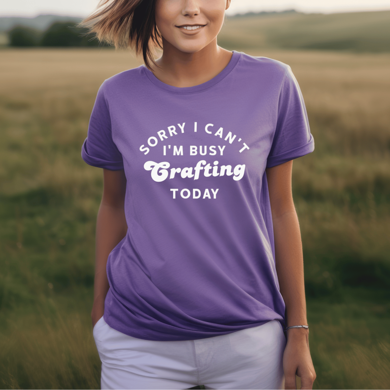 Woman wearing a purple t-shirt with text in a field