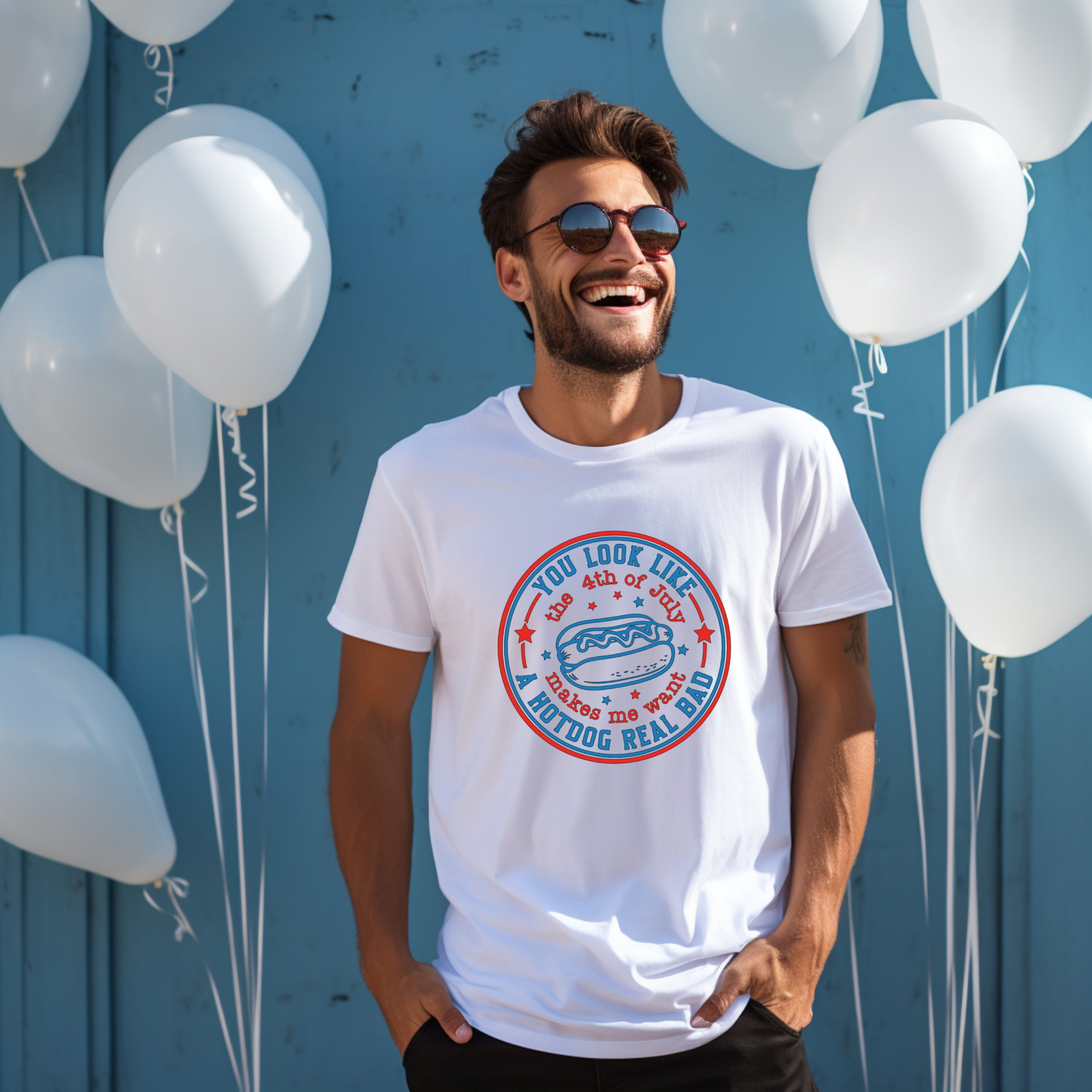 Man wearing a white t-shirt with a graphic design in front of white balloons against a blue wall.