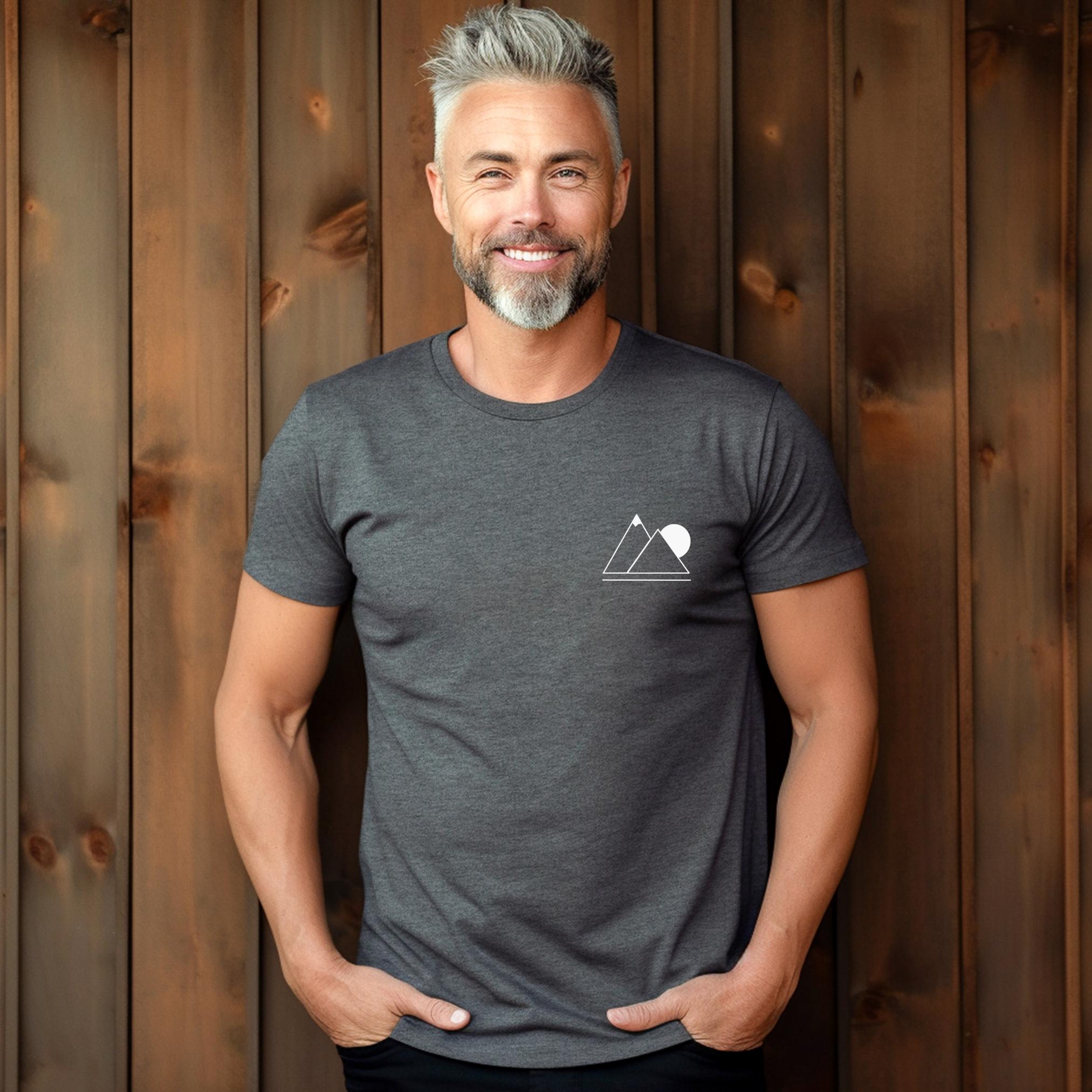 A person wearing a dark gray t-shirt with a simple geometric mountain silhouette on the front.