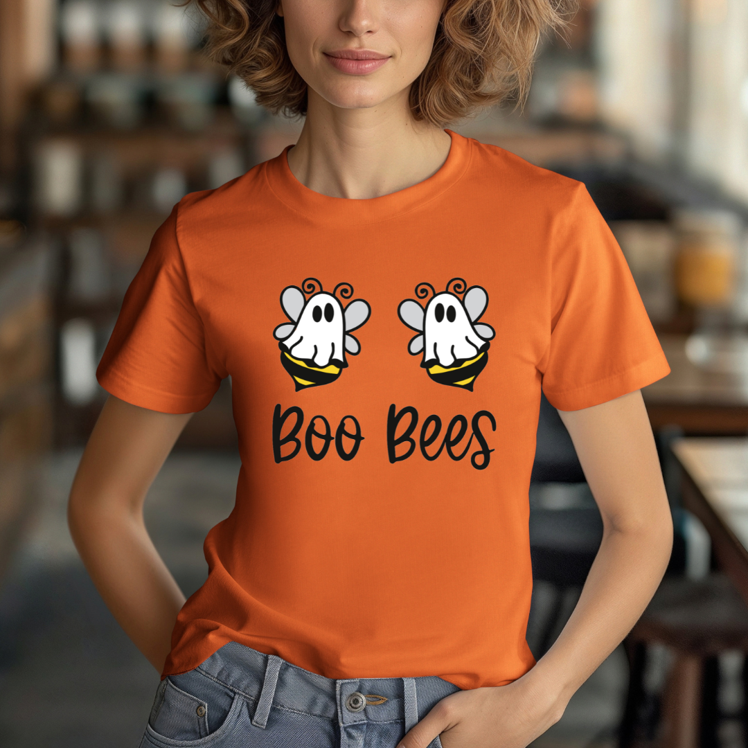 Person wearing an orange t-shirt with 'Boo Bees' design in a casual setting
