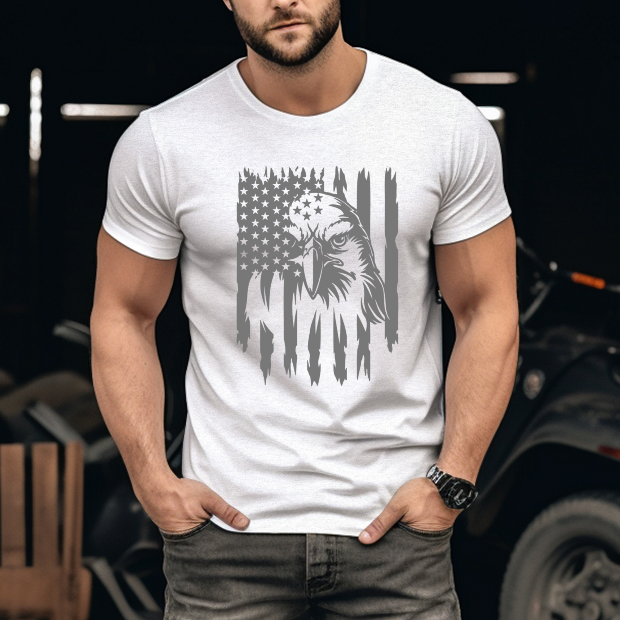 Man wearing a white t-shirt with an eagle and flag design, standing in front of a blurred background.