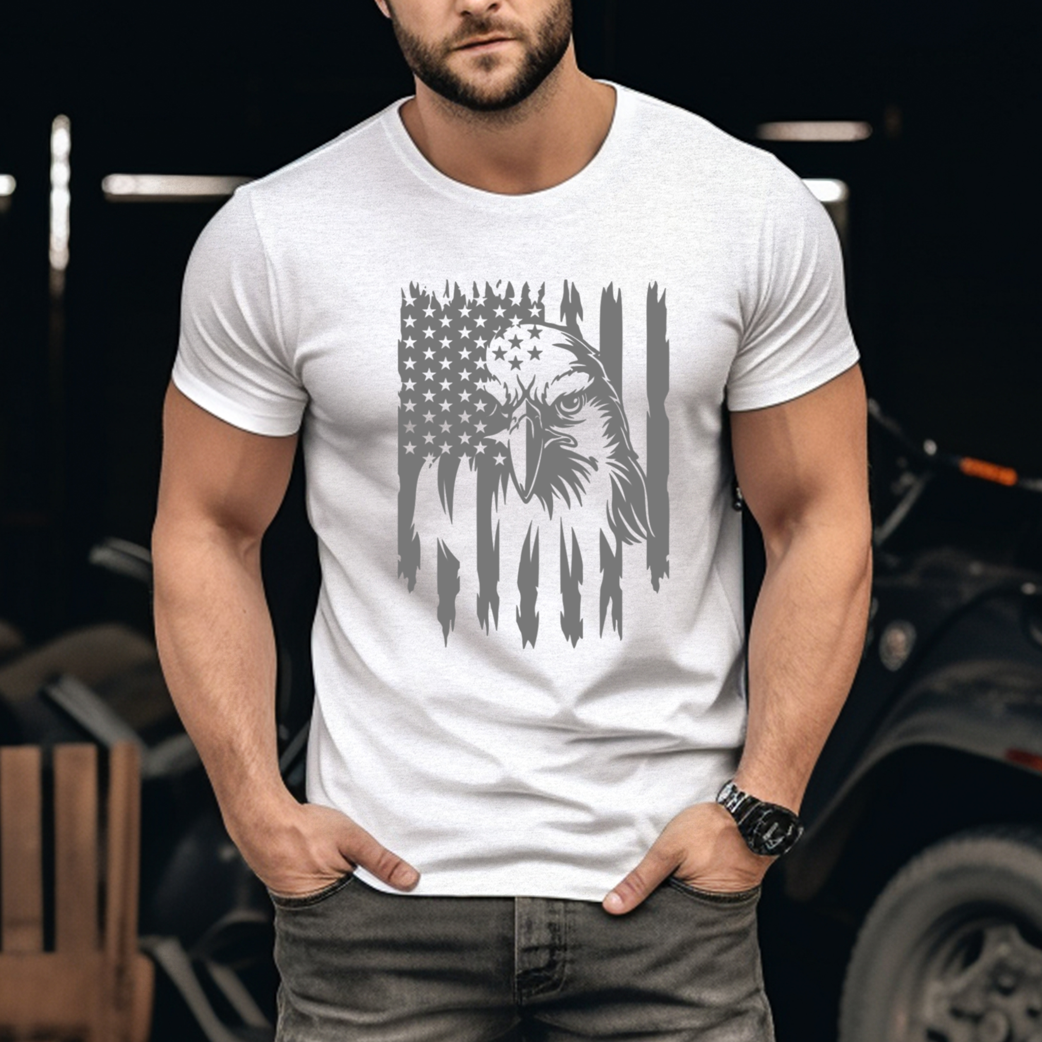 Man wearing a white t-shirt with an eagle and flag design, standing in front of a blurred background.