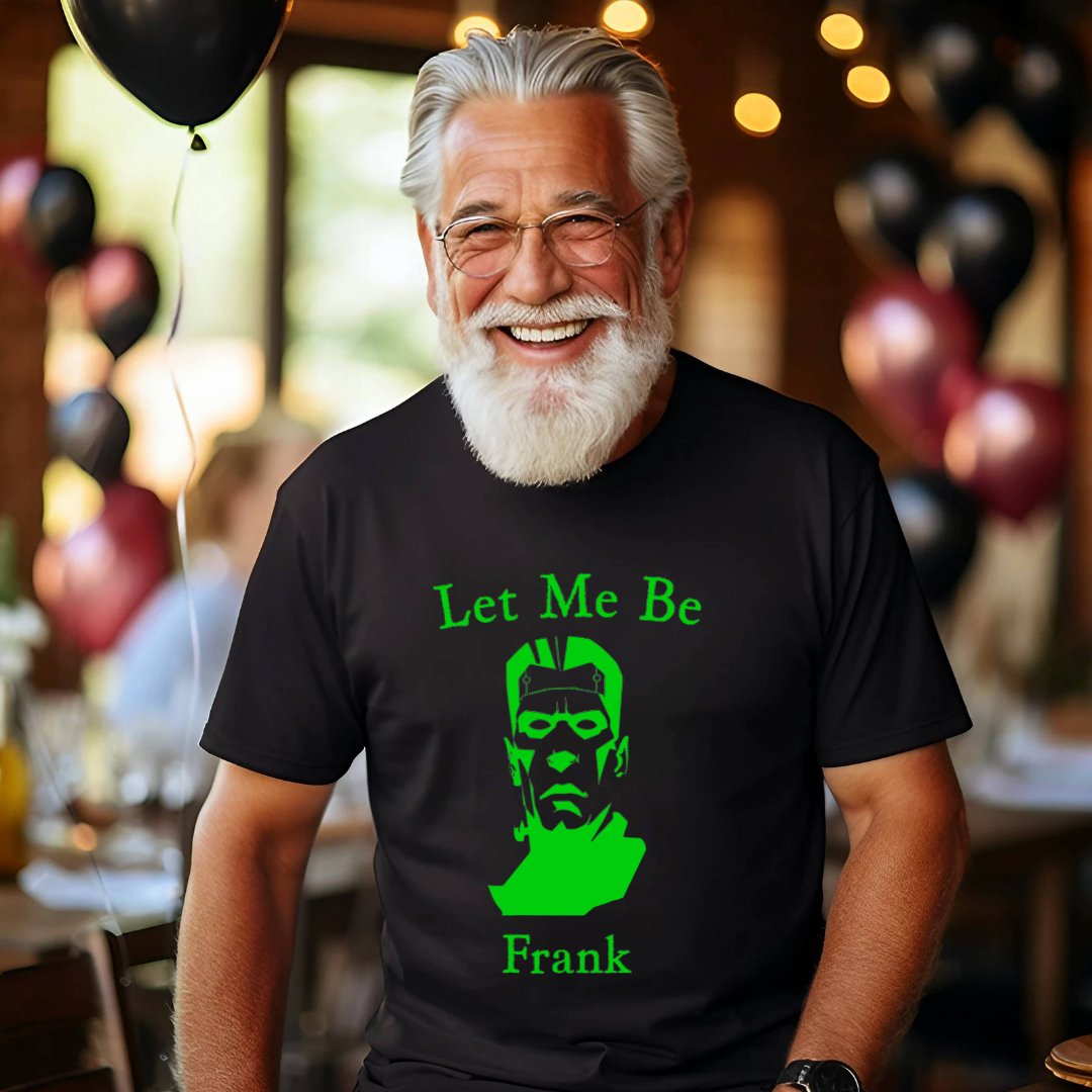 Man wearing a black t-shirt with a green graphic and text, standing in a festive indoor setting with balloons.
