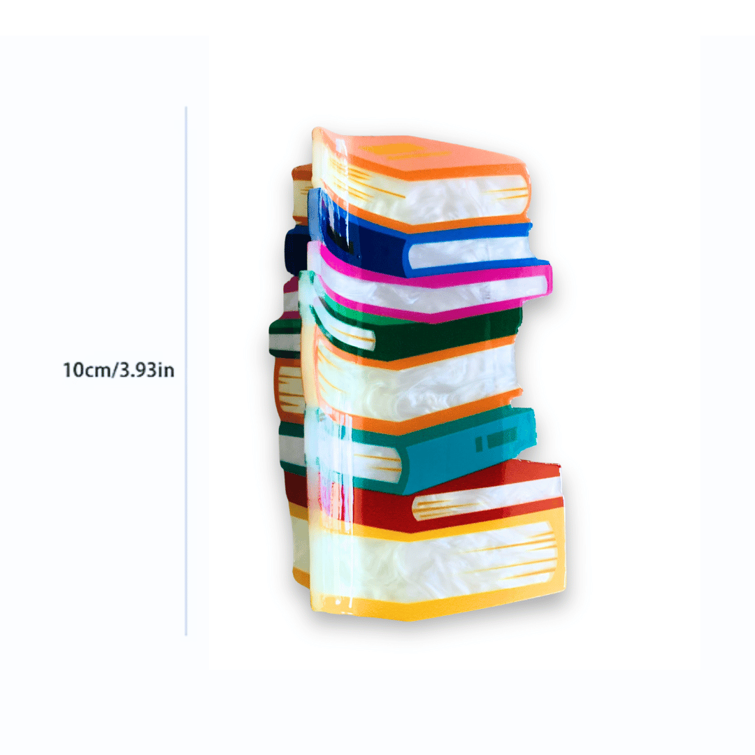 A colorful hair clip in the image of a stack of books, measuring 4 inches.