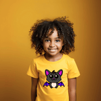 Child wearing a yellow t-shirt with a cartoon bat design on a mustard yellow background
