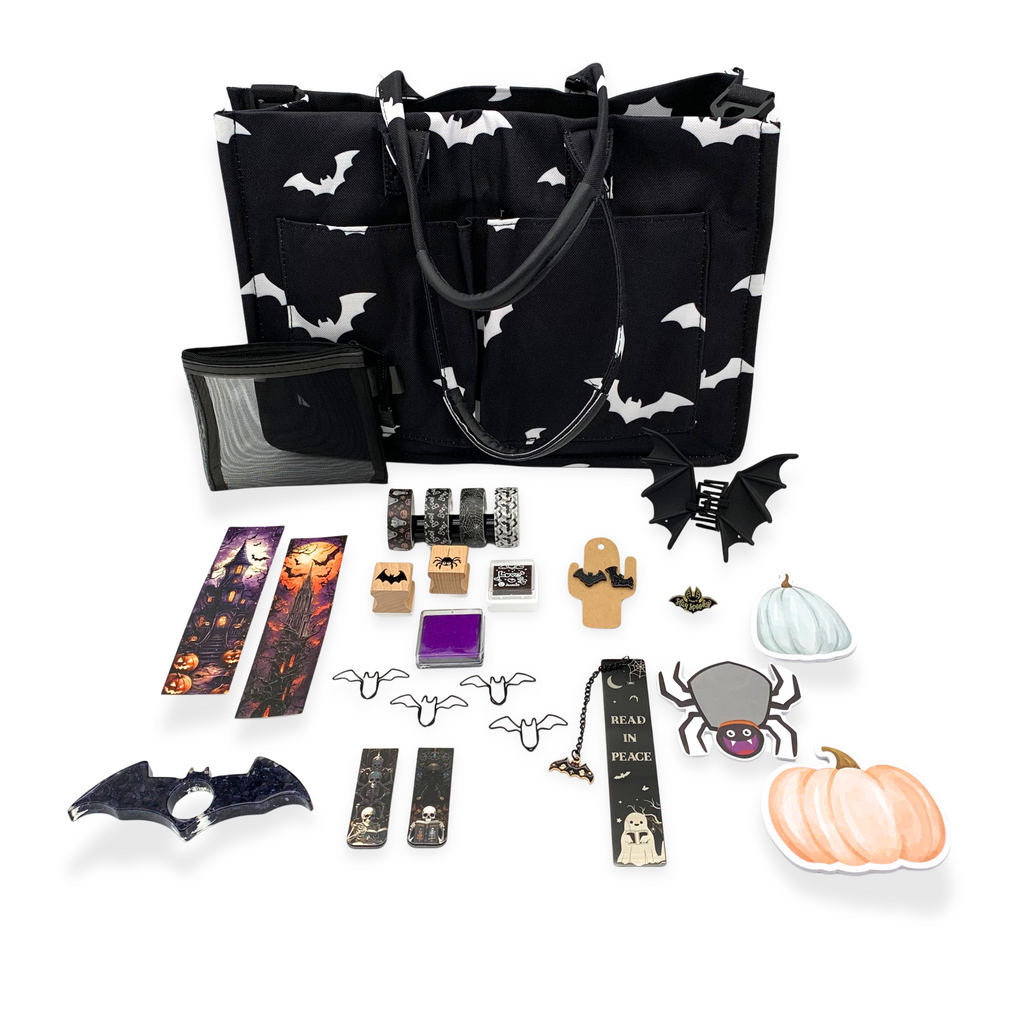 Black tote bag with white bat pattern, various Halloween-themed accessories on a white background
