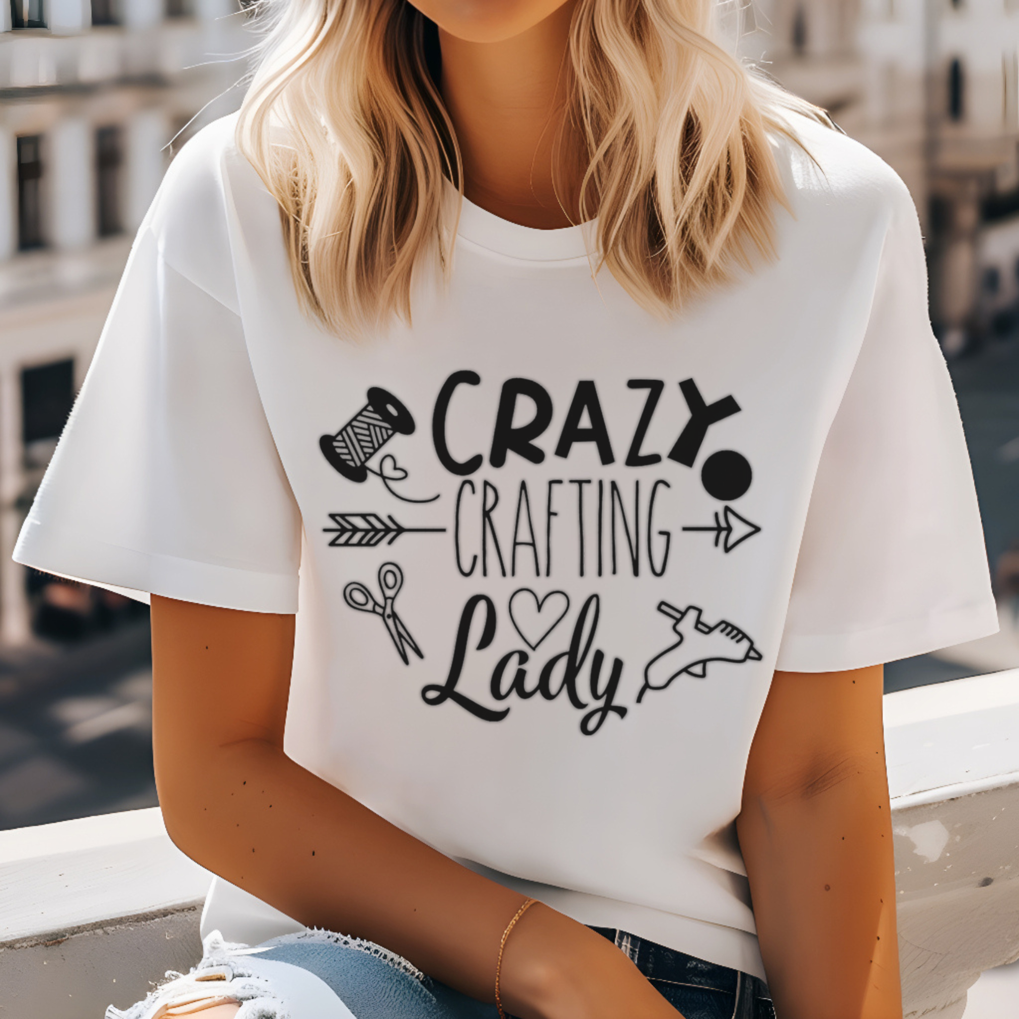 Person wearing a white t-shirt with 'Crazy Crafting Lady' text and graphics.