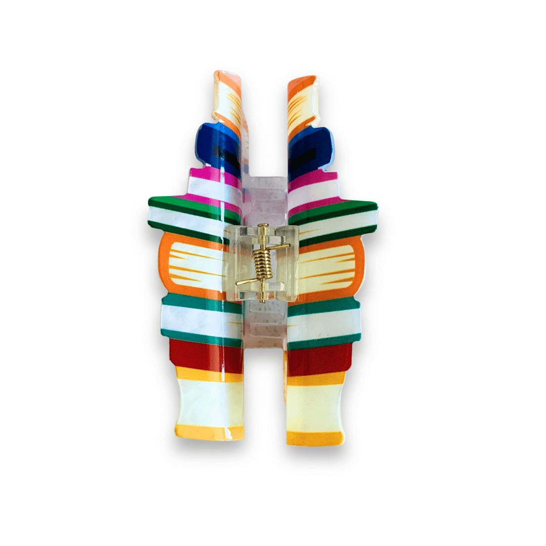 A colorful hair clip in the image of a stack of books.