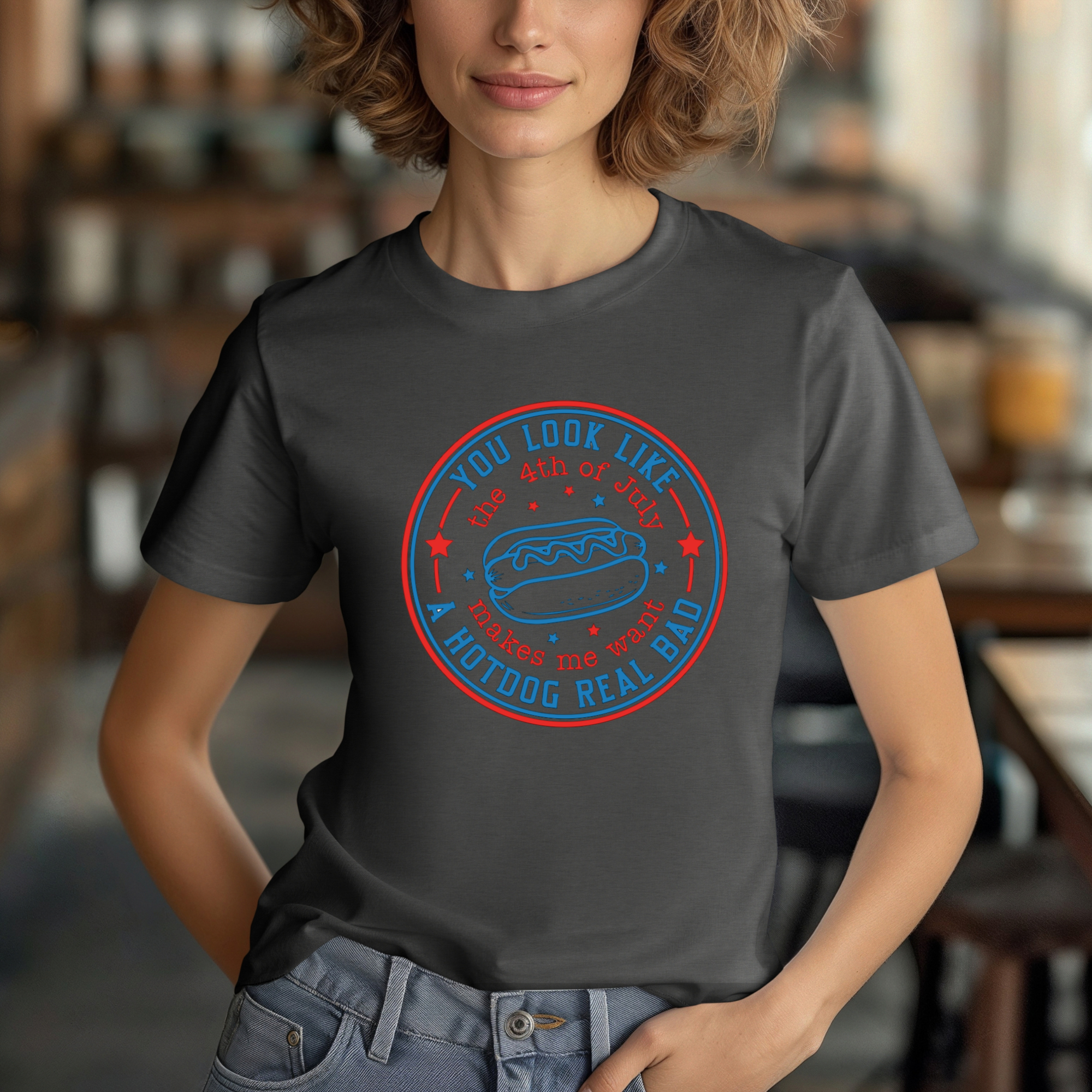 Person wearing a dark gray t-shirt with a graphic design in a casual setting