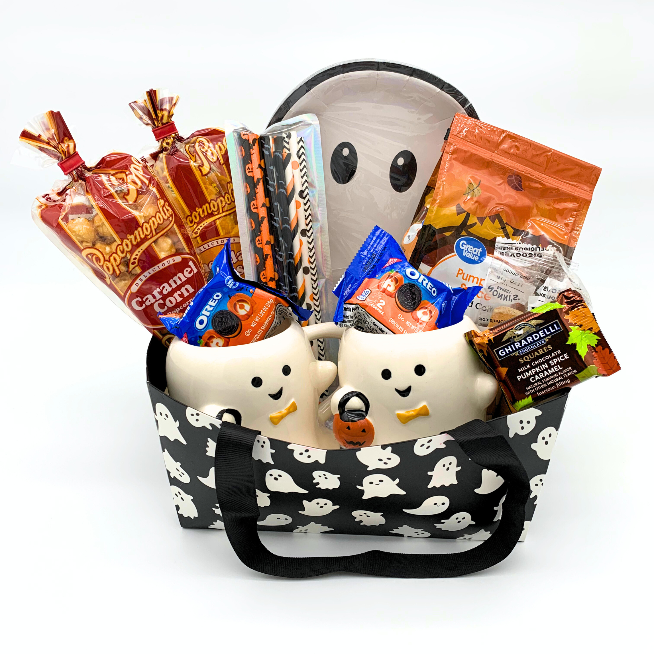Halloween-themed gift basket with ghost design filled with snacks and treats on a white background