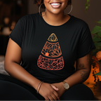 Woman wearing a black t-shirt with a geometric design, sitting in a room with plants.