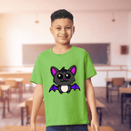 Child wearing a green t-shirt with a cartoon cat design in a classroom setting