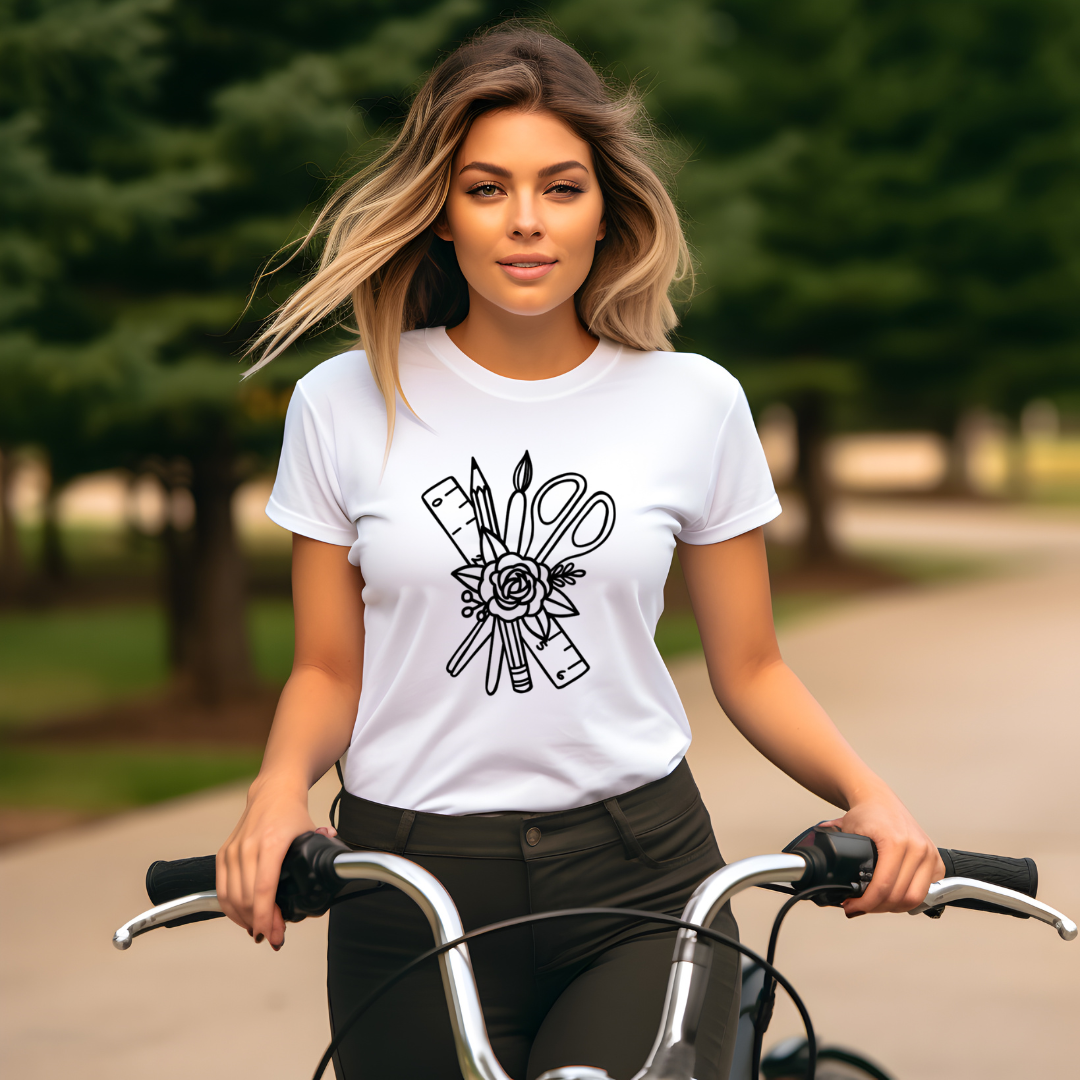 Woman riding a bicycle wearing a white t-shirt with a black graphic design.