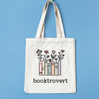 Tote bag with 'booktrovert' design on a blue background