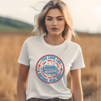Woman wearing a white t-shirt with a graphic design in a field