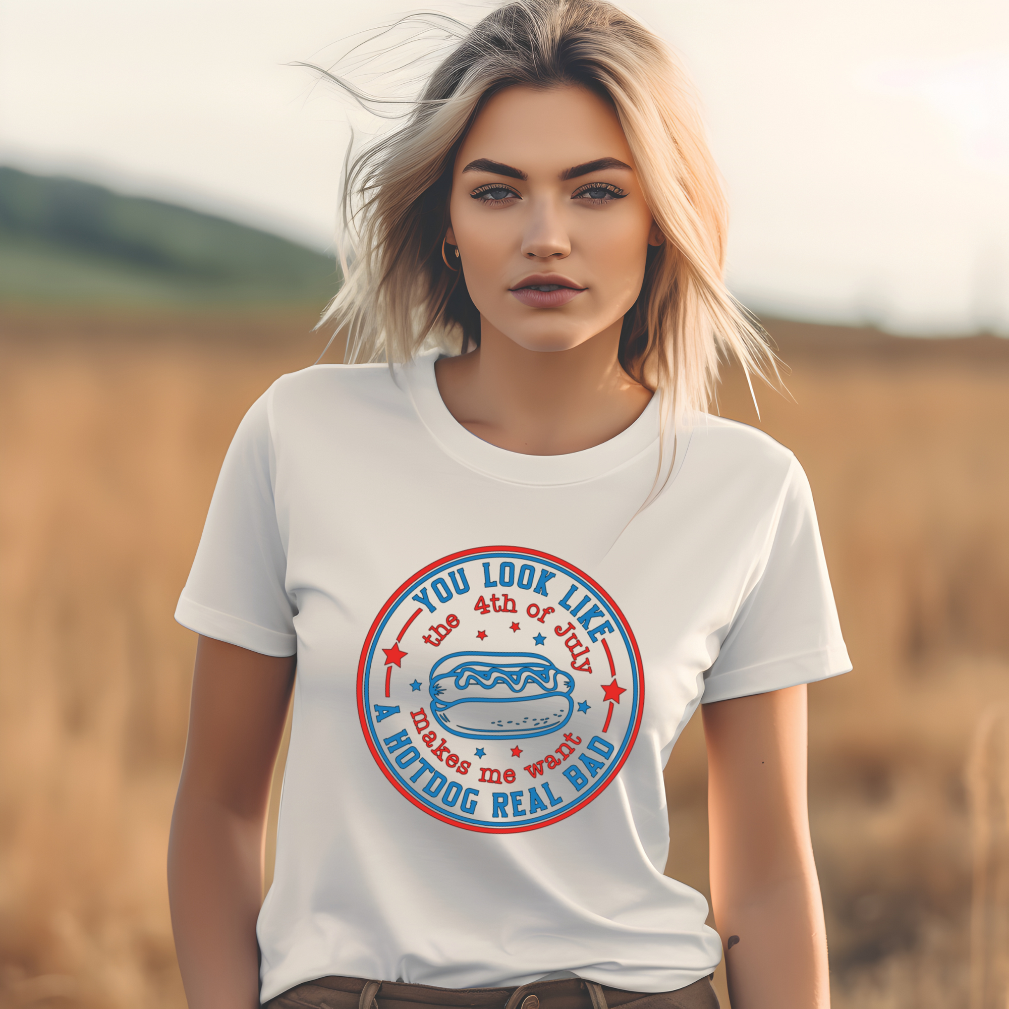 Woman wearing a white t-shirt with a graphic design in a field