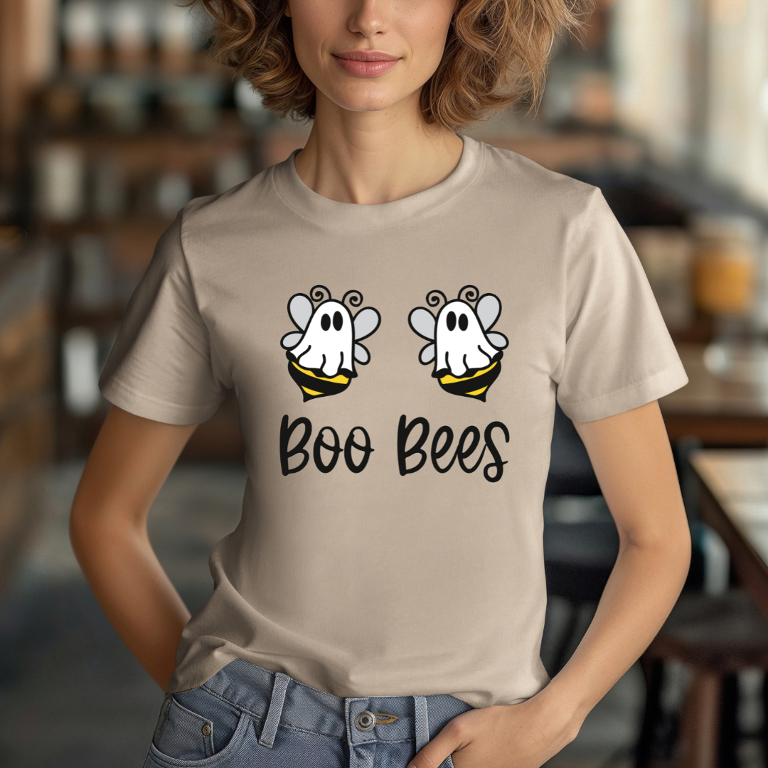 Person wearing a tan t-shirt with 'Boo Bees' design in a casual setting