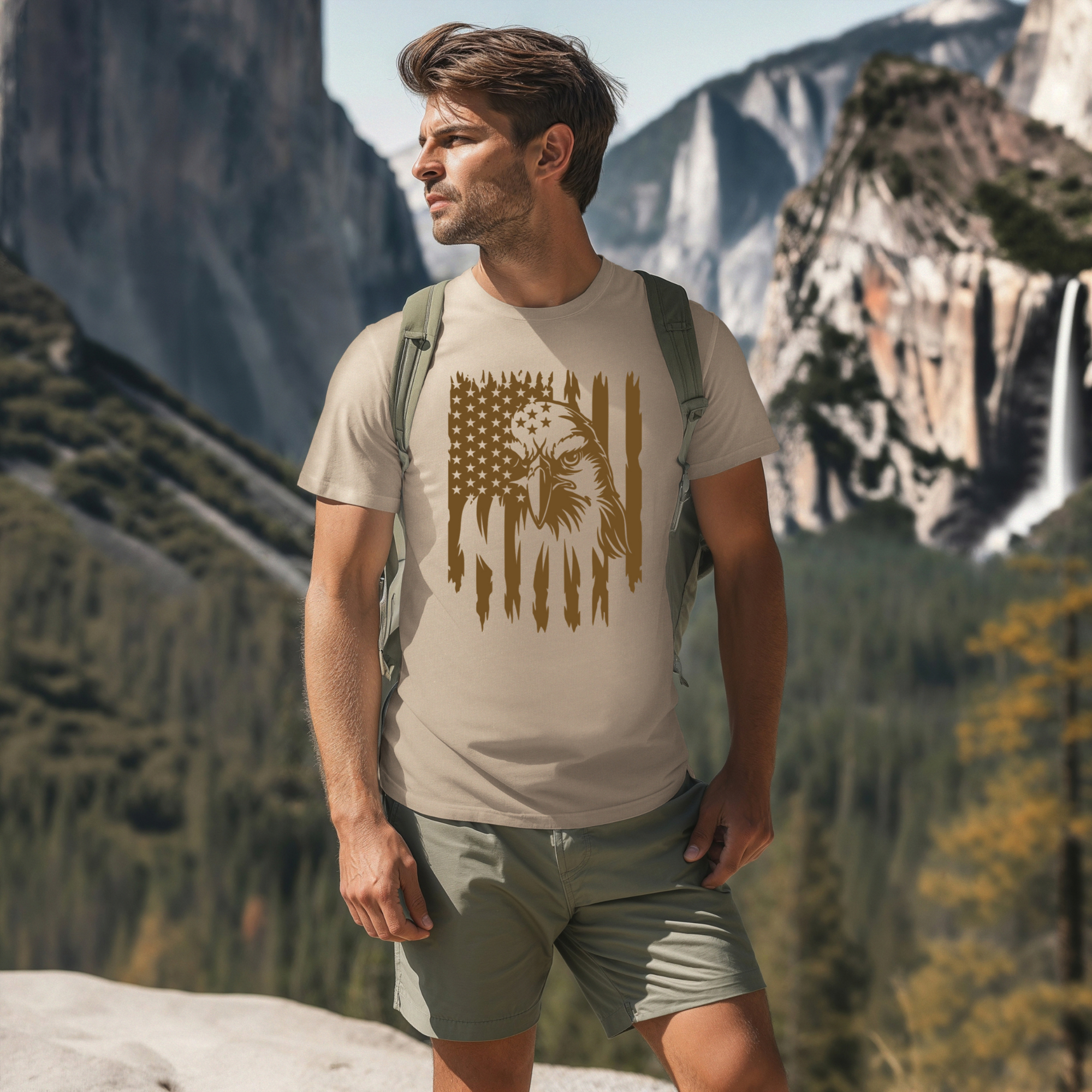 Man wearing a t-shirt with an eagle design in a mountainous landscape