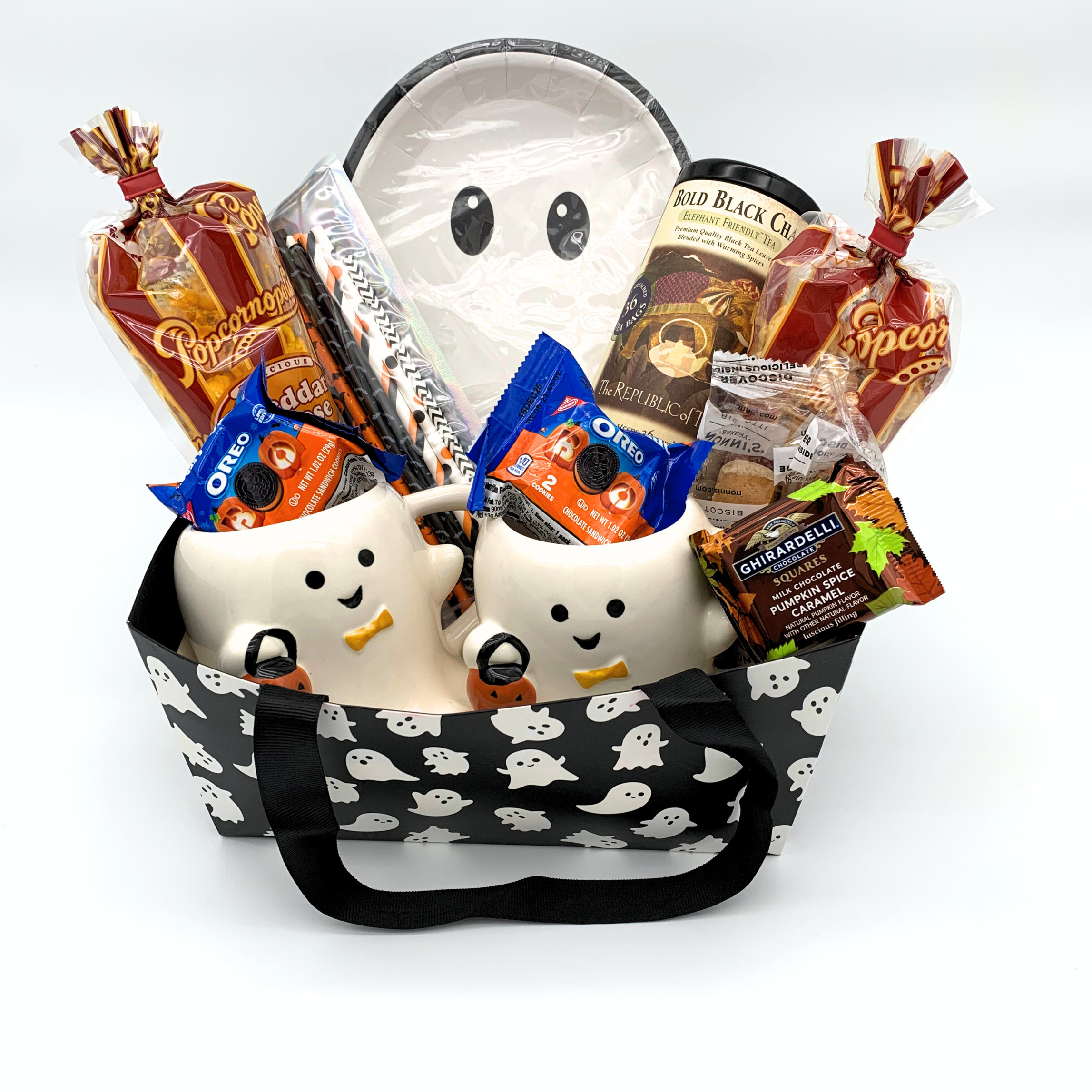 Halloween-themed gift basket with ghost design and candy on a white background