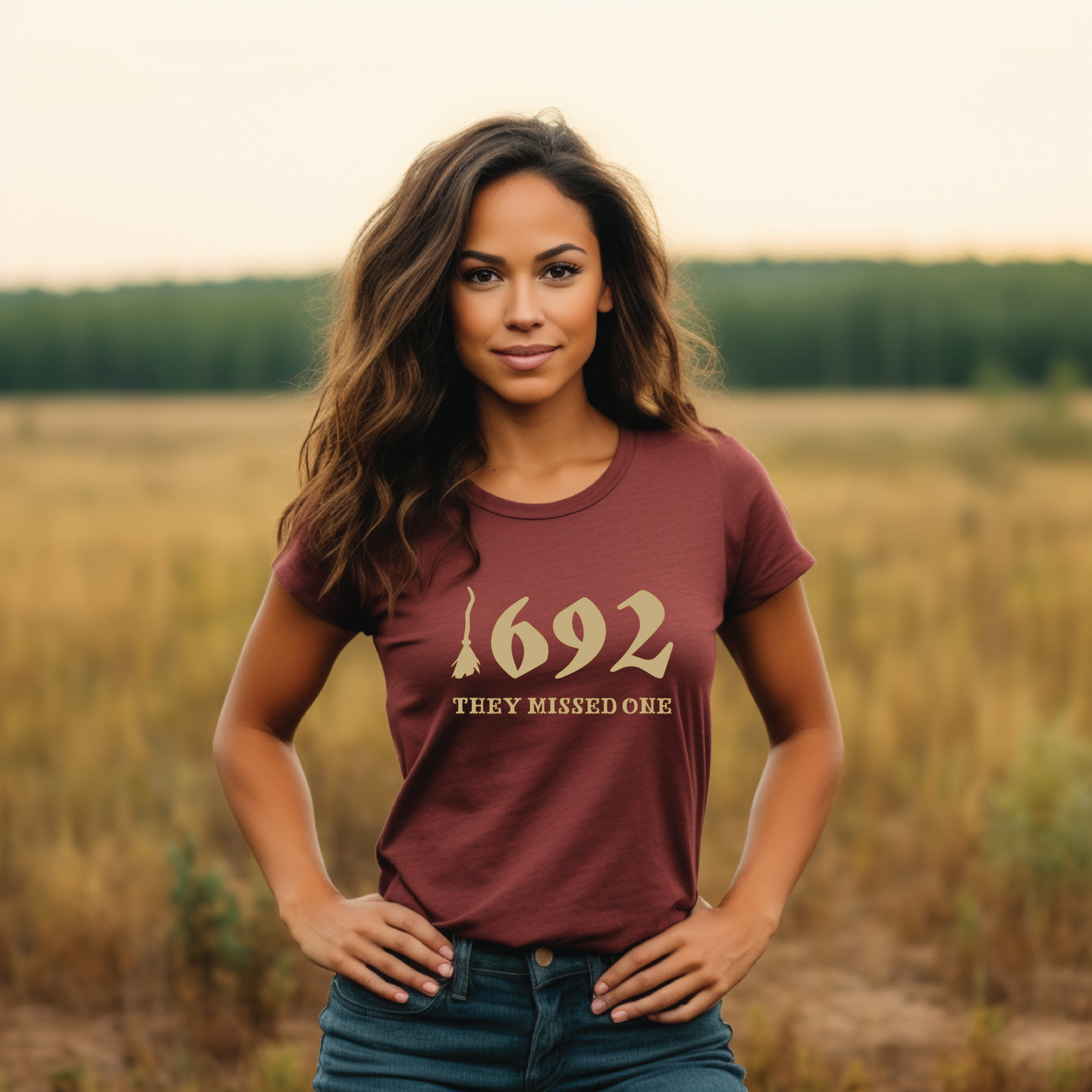 A person standing in a field wearing a t-shirt with the text '1692 THEY MISSED ONE' on it.