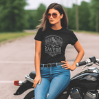 Woman wearing a black t-shirt with a graphic design, sitting on a motorcycle.