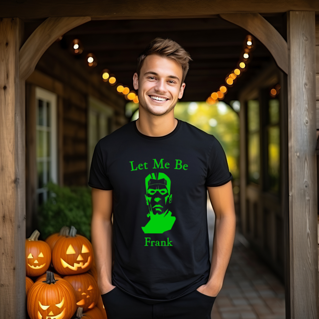 Person wearing a black t-shirt with green text and graphic, standing in front of pumpkins.