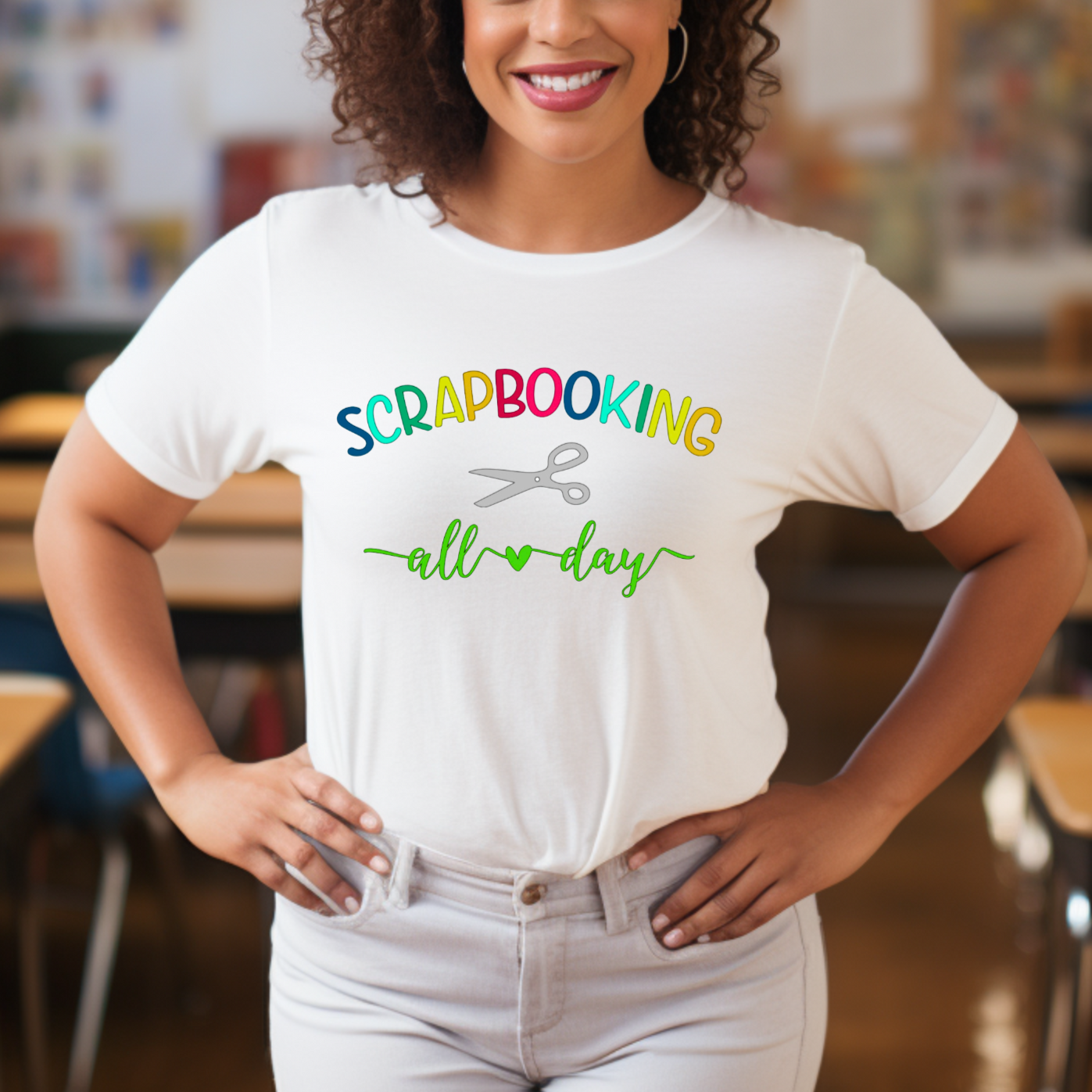 A person wearing a white t-shirt with rainbow text and a pair of scissors icon, indicating a scrapbooking theme.