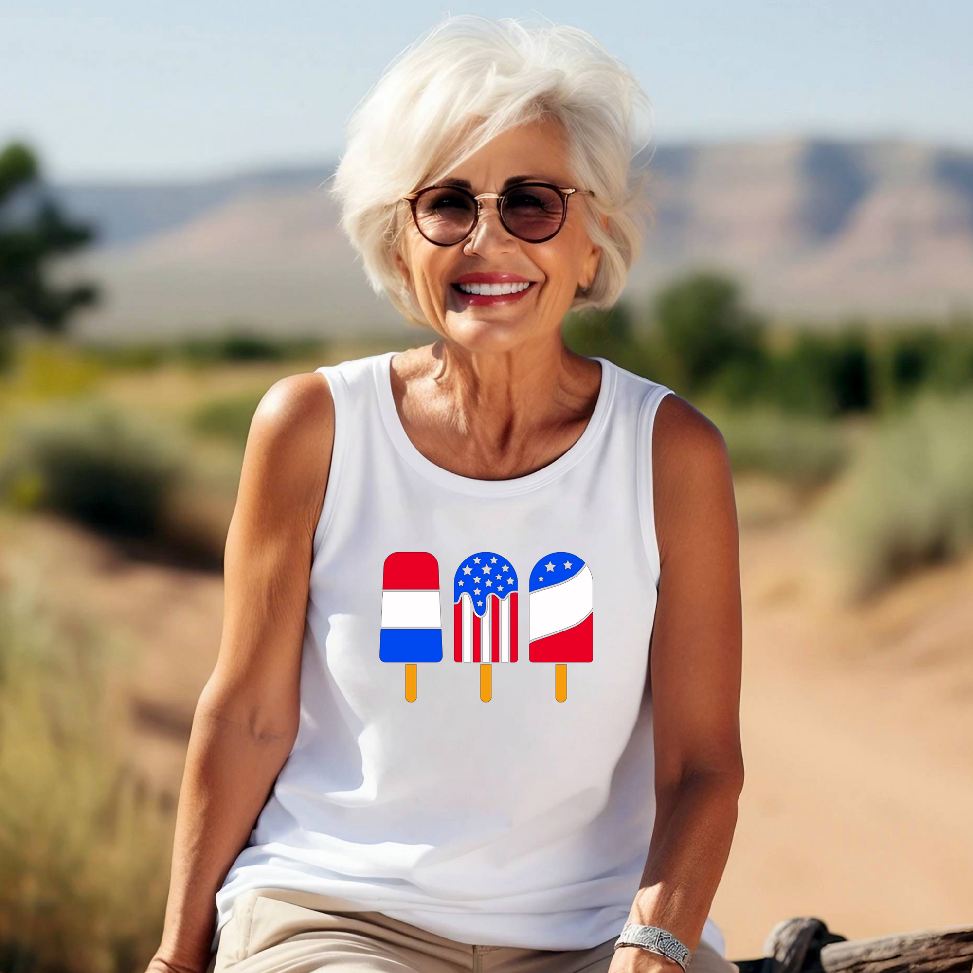Woman wearing a white tank top with colorful designs outdoors