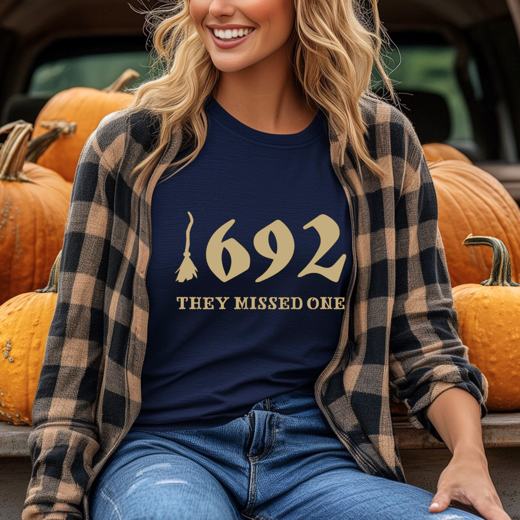 A person with red hair wearing a gray t-shirt with the text '1692 THEY MISSED ONE' on it.