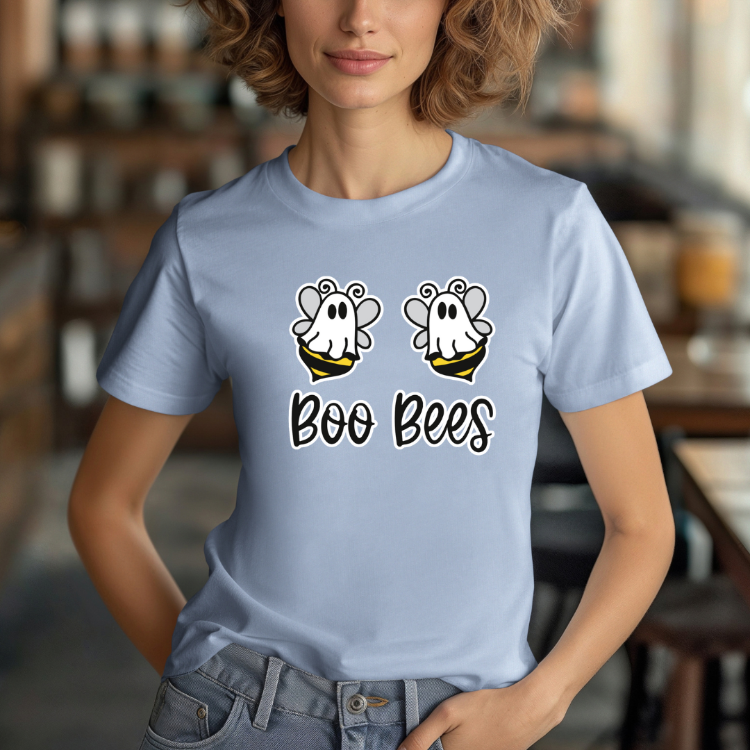Person wearing a light blue t-shirt with 'Boo Bees' design in a casual setting.