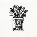 Illustration of flowers in a book with text on a white background that says 'Between the pages is a lovely place to be'