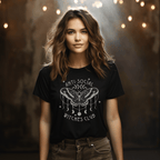 Woman wearing a black t-shirt with a moth design and text against a warm, blurred background.