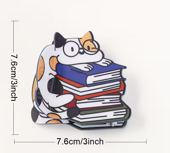 Measurements of the hair clip featuring a cartoon cat hugging a stack of books  3in by 3in
