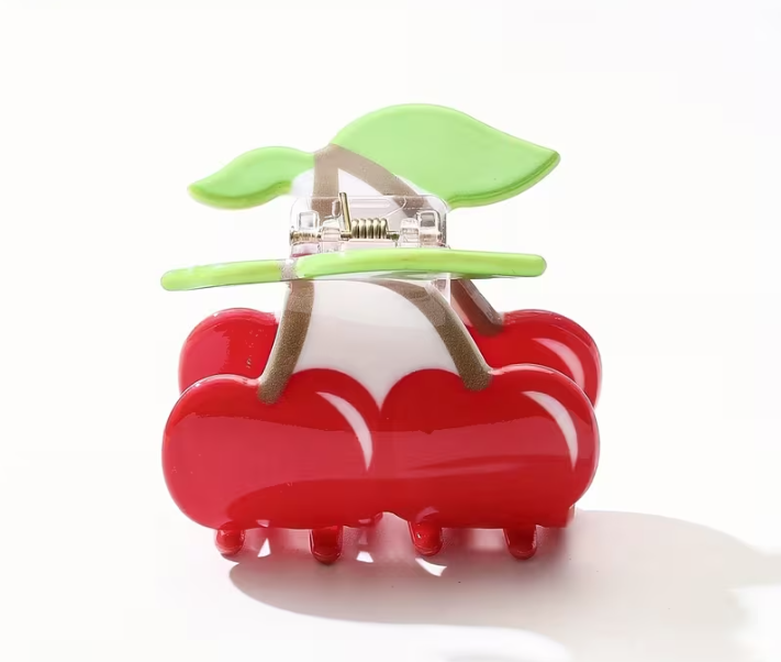 Red and green cherry themed hair clip on a white background