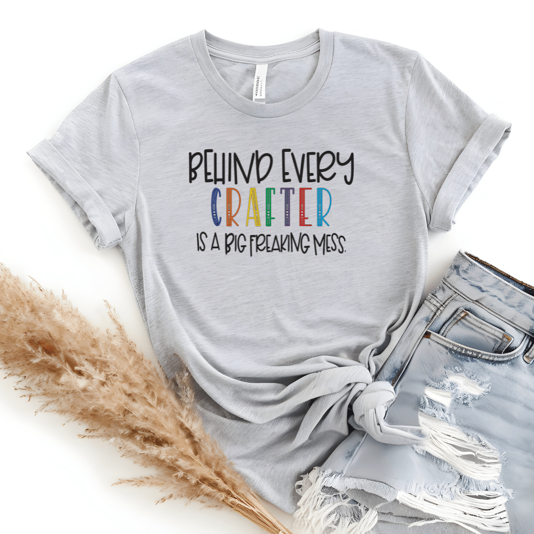 Behind Every Crafter Is A Big Freaking Mess funny t-shirt in gray with rainbow lettering