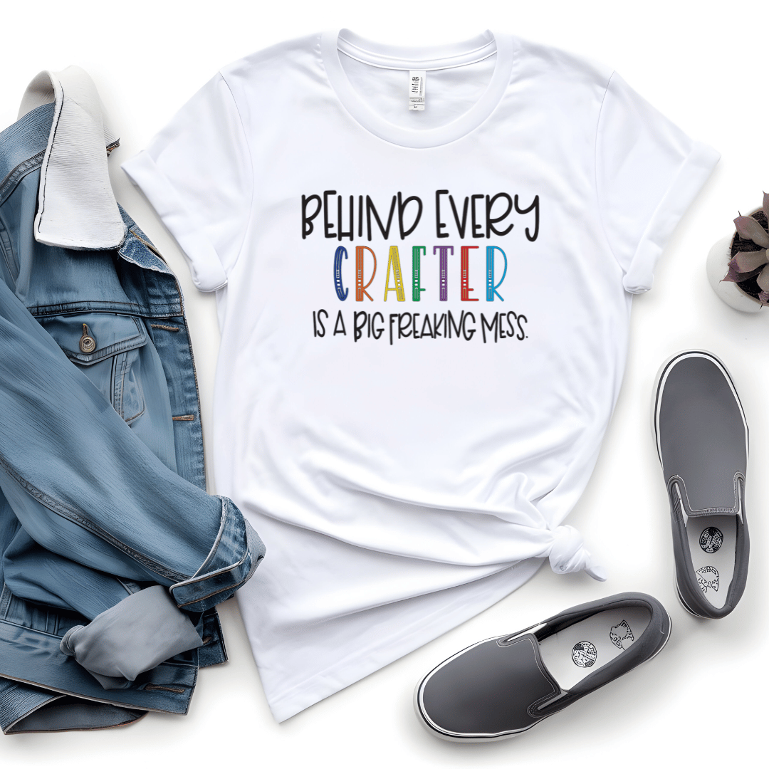 Behind Every Crafter Is A Big Freaking Mess funny t-shirt in white with rainbow lettering