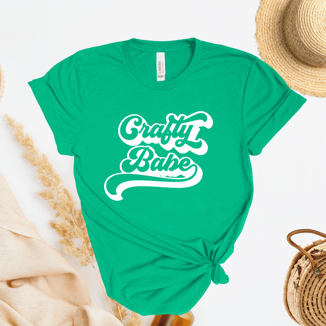 Green t-shirt with 'Crafty Babe' text on a white background