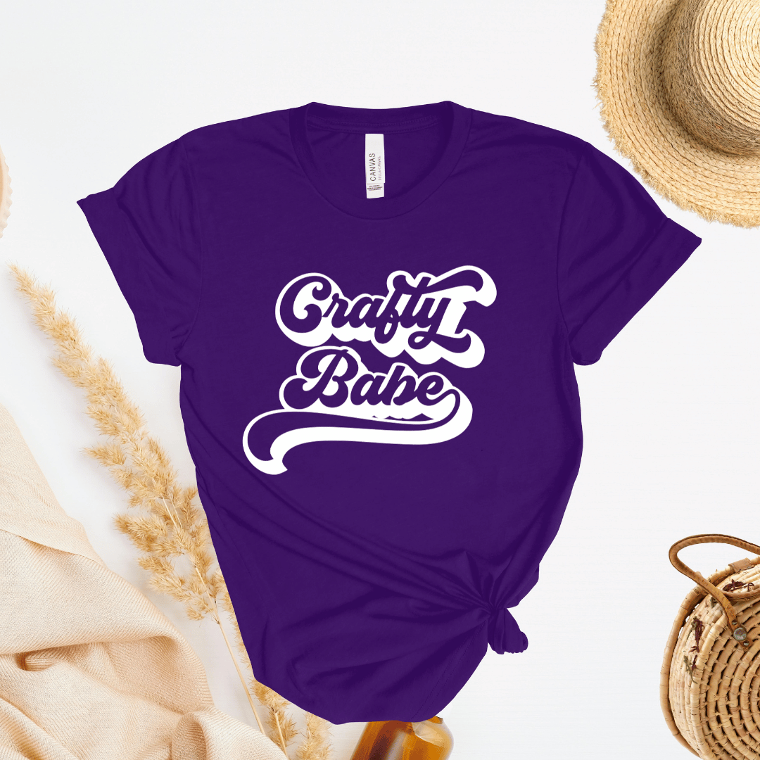 Purple t-shirt with 'Crafty Babe' text on a light background