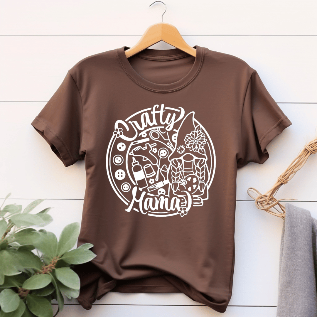 Brown t-shirt with 'Crafty Mama' design with buttons and craft supplies.