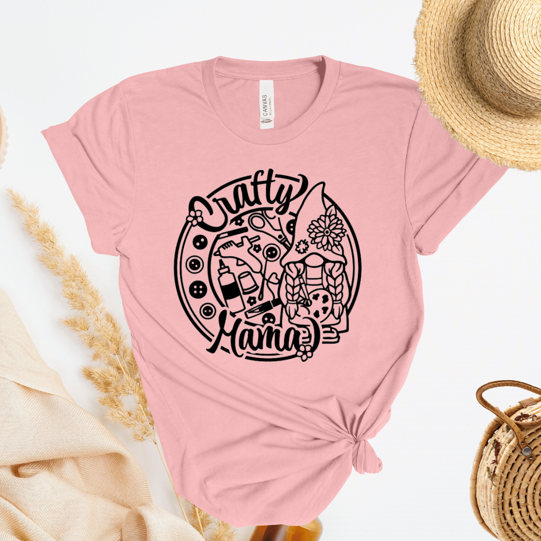 Pink t-shirt with 'Crafty Mama' design with buttons and craft supplies.
