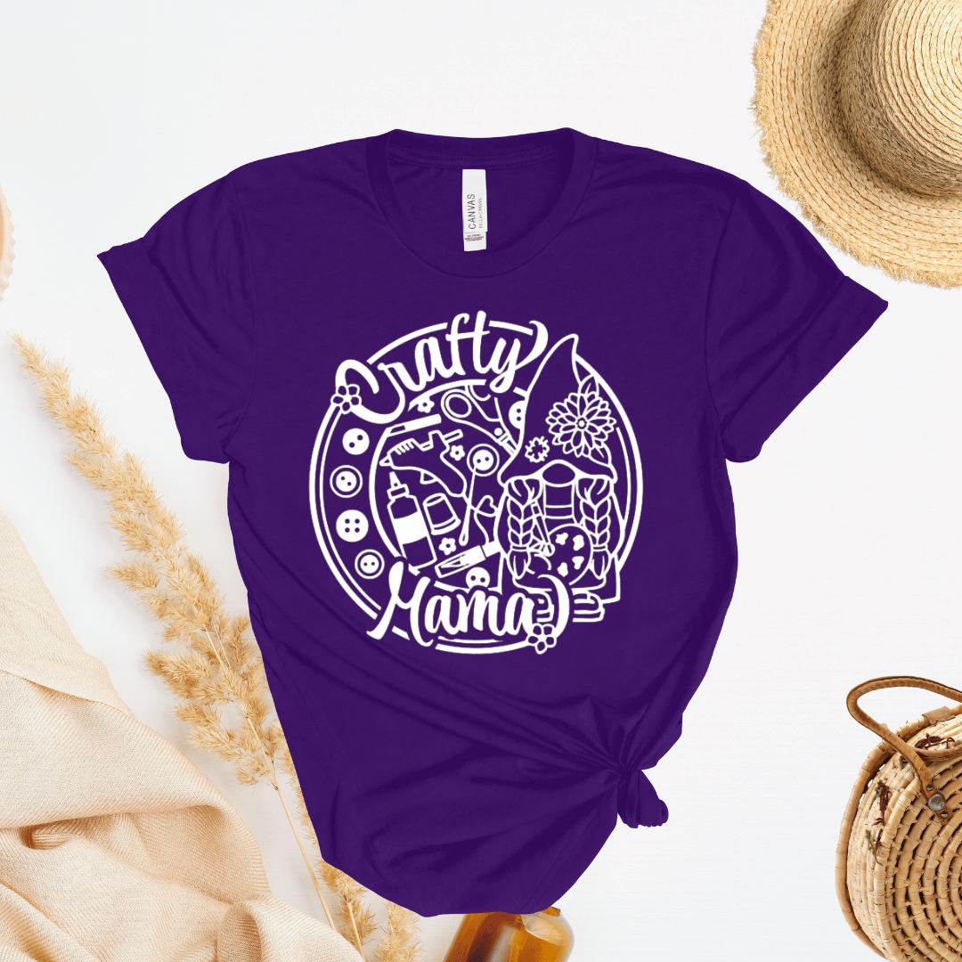 Purple t-shirt with 'Crafty Mama' design with buttons and craft supplies.