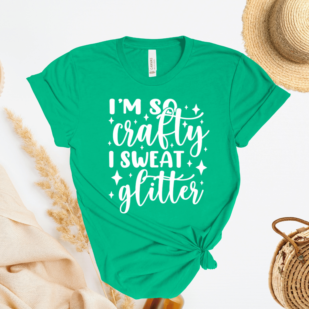 Green t-shirt with 'I'm so crafty I sweat glitter' text on a white background