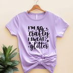 Purple t-shirt with 'I'm so crafty I sweat glitter' text on a beige background