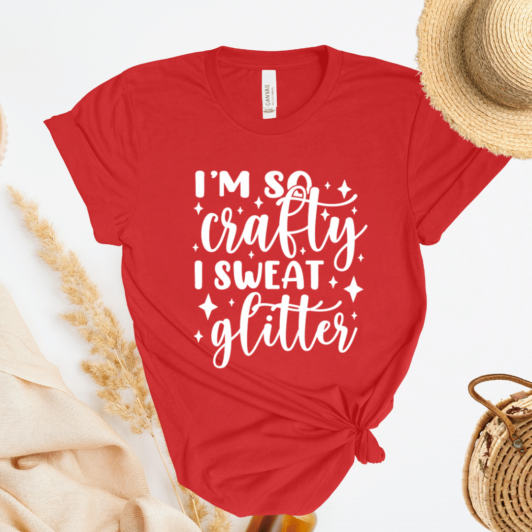 Red t-shirt with 'I'm so crafty I sweat glitter' text on a white background