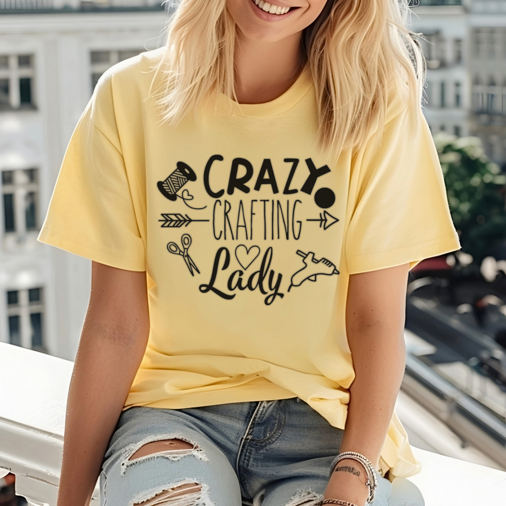 Person wearing a yellow t-shirt with 'Crazy Crafting Lady' text and graphics.