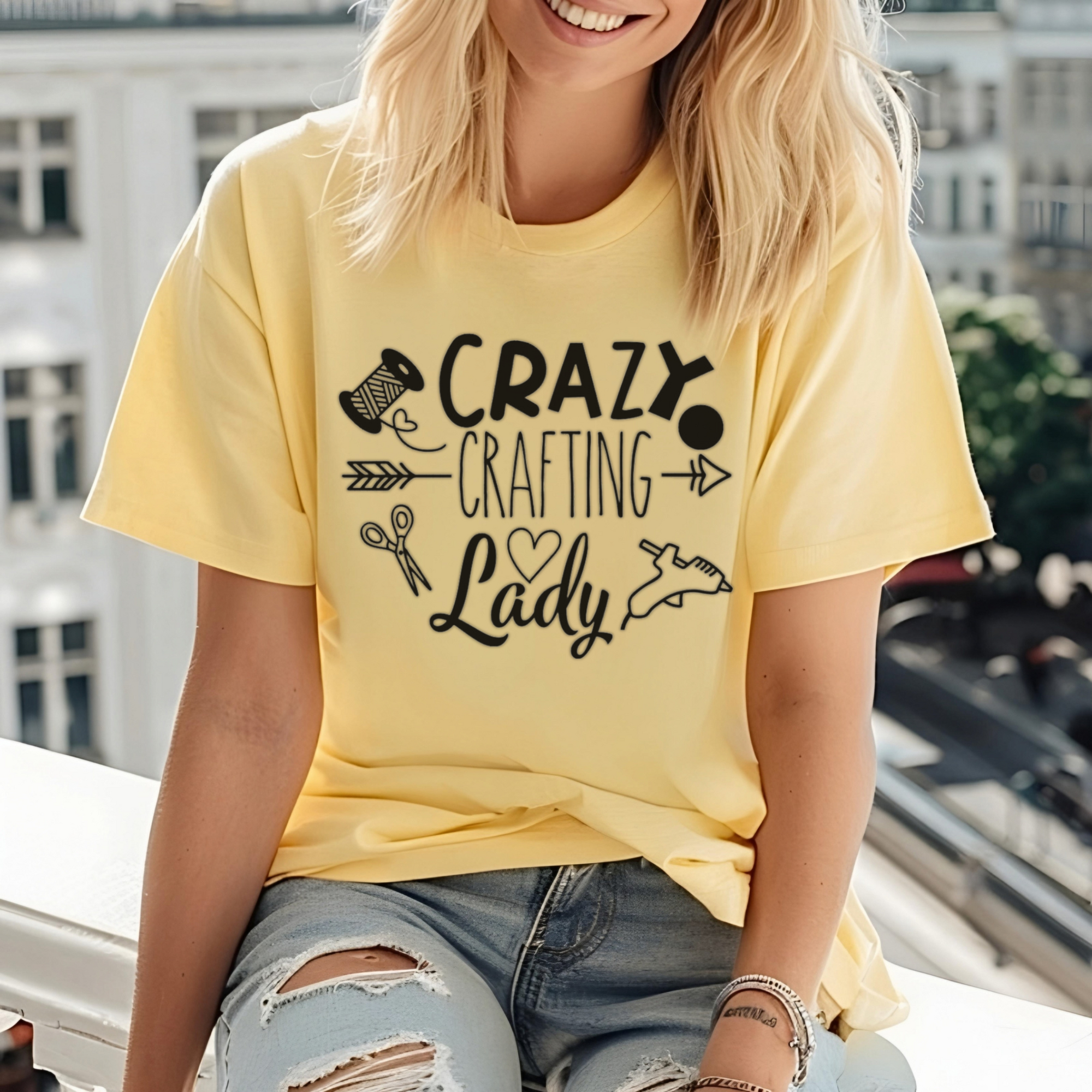 Person wearing a yellow t-shirt with 'Crazy Crafting Lady' text and graphics.