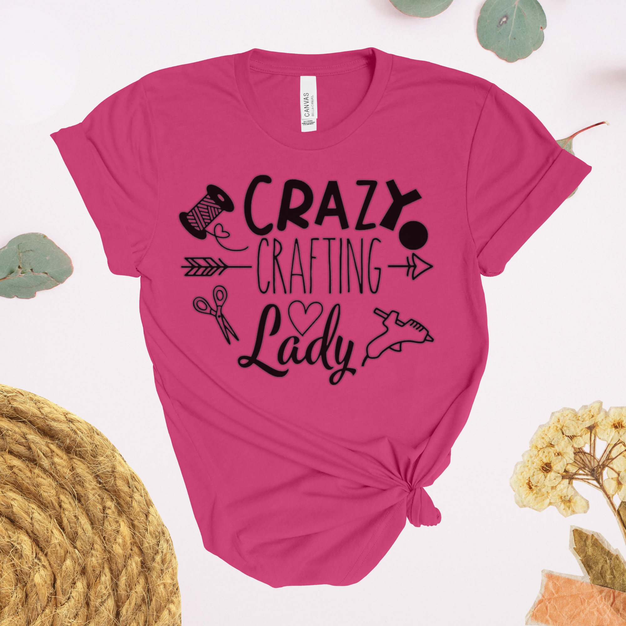 Pink t-shirt with 'Crazy Crafting Lady' text and graphics on a light background